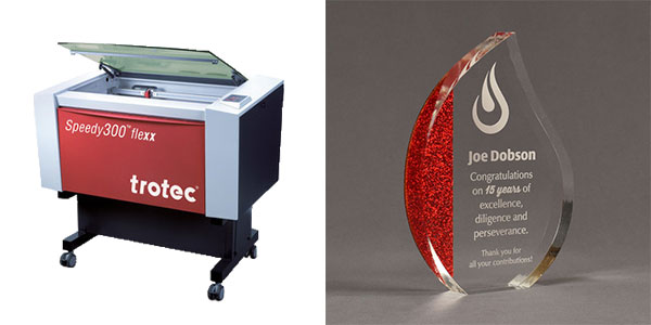 Trotec Laser engraver with image of a laser engraved acrylic award to the right.